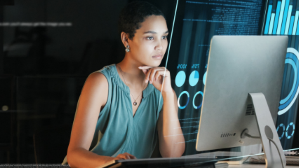 Photo of man looking at computer monitors. Photo of a woman looking at data on a computer monitor.