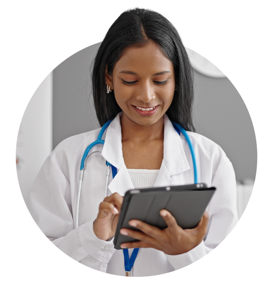 Photo of woman physician using a tablet image. Photo of woman physician using a tablet image.